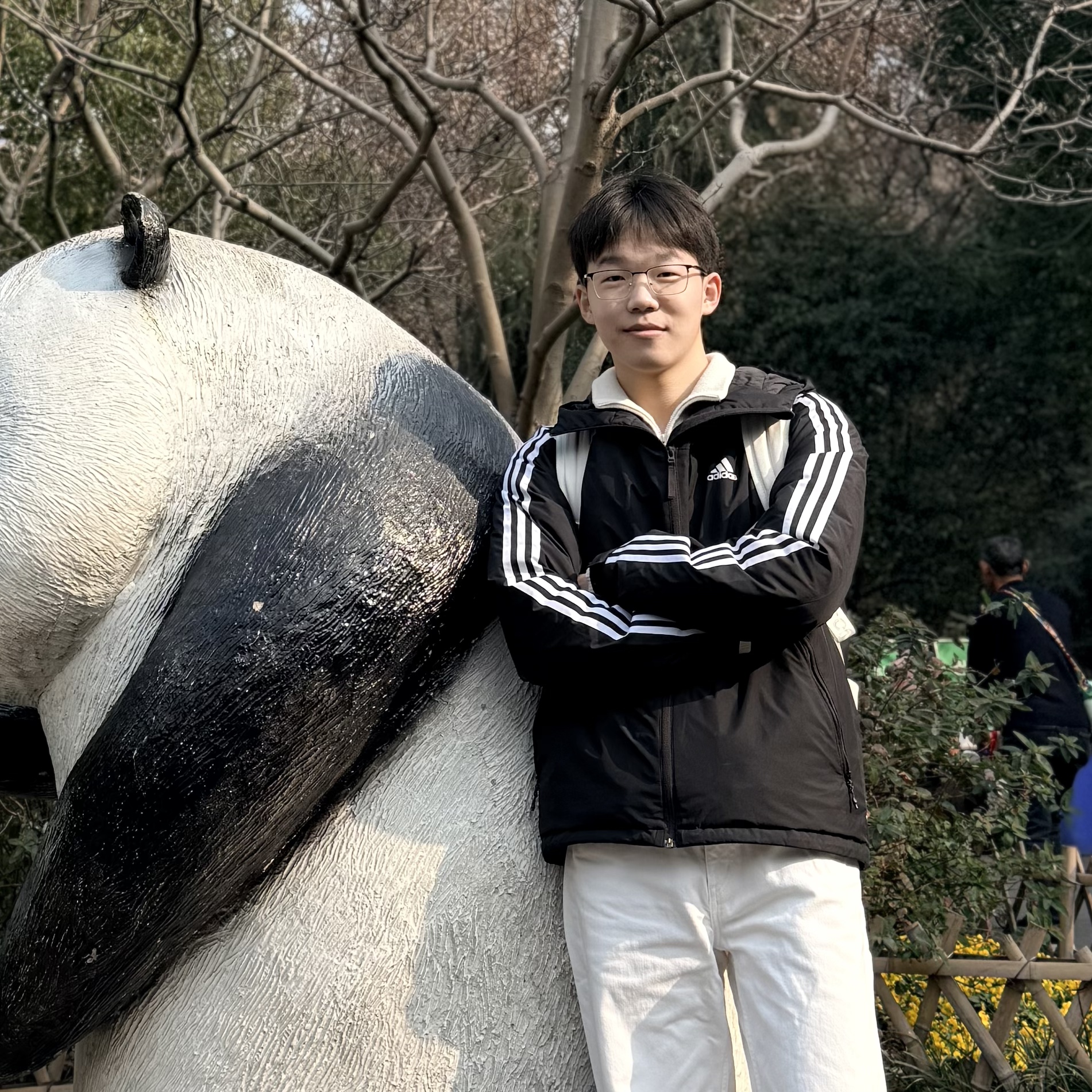 Jialei Li standing beside a panda sculpture